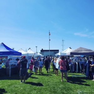 Crowds of people explore an outdoor market